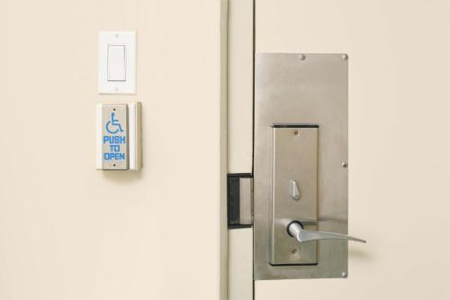 a metal door with a sign on it at Aston Waikiki Circle Hotel in Honolulu