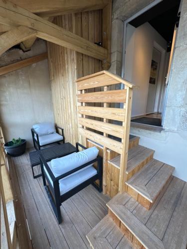 a wooden stairs with a bench and a stair case at Le Saint-André - Clim - Loft romantique avec Jacuzzi in Buxy