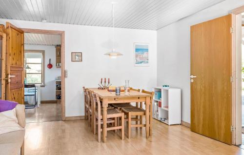 a kitchen and dining room with a wooden table and chairs at Gorgeous Home In Jerup With Wifi in Jerup