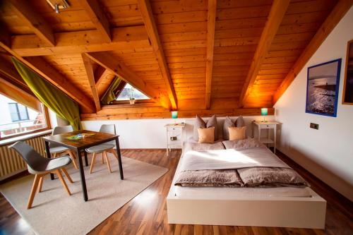 a bedroom with a bed and a table in a room at Haus Rose in Allensbach