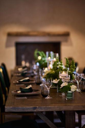 a long wooden table with wine glasses on it at The Leta Santa Barbara Goleta, Tapestry Collection by Hilton in Santa Barbara