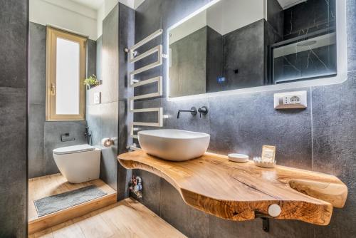 a bathroom with a sink on a wooden counter at 4 Pax Wi-Fi Milano Lorenteggio in Milan
