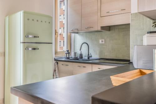 a kitchen with a refrigerator and a sink at 4 Pax Wi-Fi Milano Lorenteggio in Milan