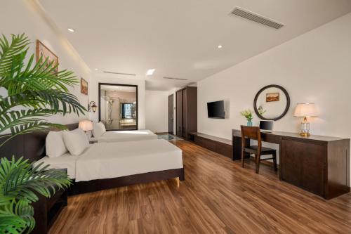 a hotel room with a bed and a desk and a mirror at Nostalgia Boutique Hotel in Da Nang