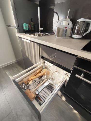 an open drawer in a kitchen with a sink at Happy Moments 2 in Gornje Jesenje