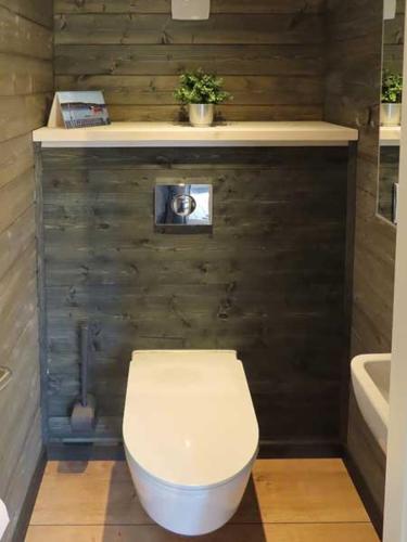 a bathroom with a toilet and a sink and a tub at Guldborg Camping & Cottages - Superior in Guldborg