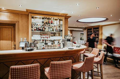 a bar in a restaurant with chairs at Landgasthof Jagstmühle in Heimhausen