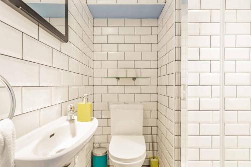 a white bathroom with a toilet and a sink at St Athans Hotel in London