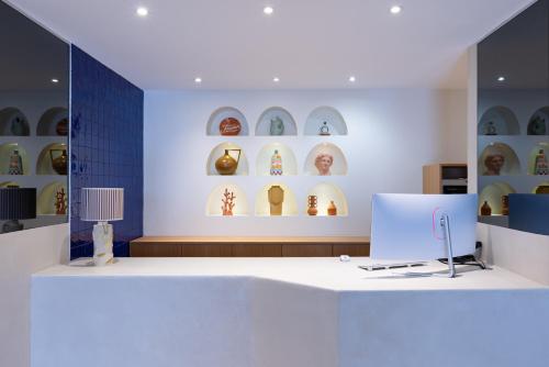 a room with a white counter and shelves of vases at Le Mariana in Calvi