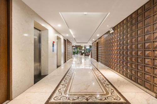 a hallway of a hotel with a tile wall at Nostalgia Boutique Hotel in Da Nang
