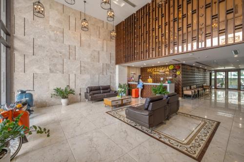 a lobby with couches and chairs in a building at Nostalgia Boutique Hotel in Da Nang