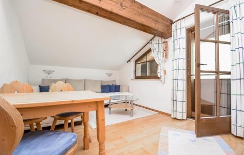 a dining room with a table and a couch at Apartment Blick Hohen Salve in Hopfgarten im Brixental