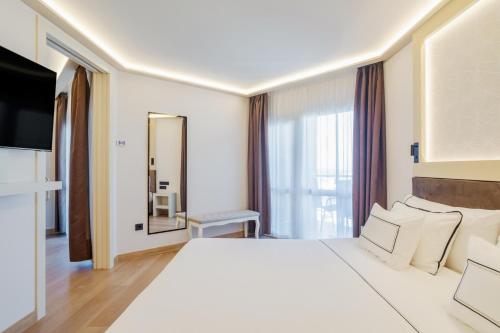 a hotel room with a large bed and a mirror at Melia Alicante in Alicante
