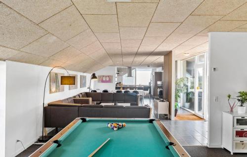 a living room with a pool table and a couch at Beautiful Home In Snedsted With Sauna in Snedsted