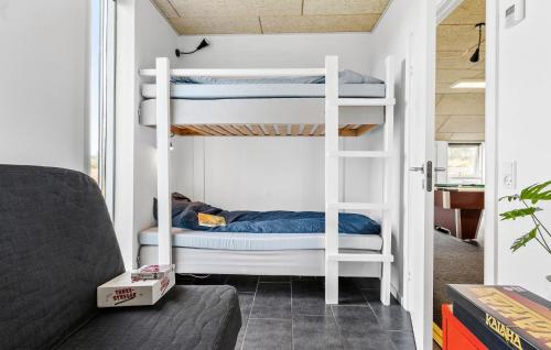 a room with two bunk beds and a couch at Beautiful Home In Snedsted With Sauna in Snedsted