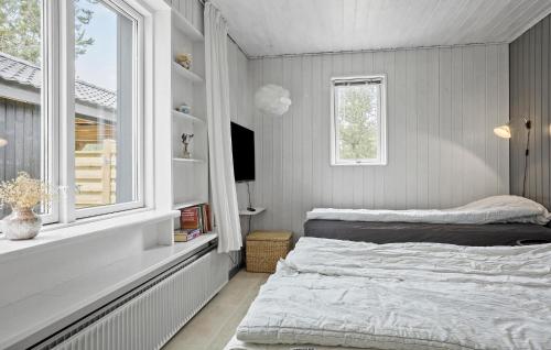 a bedroom with a bed and a window at 4 Bedroom Lovely Home In Vestervig in Vestervig