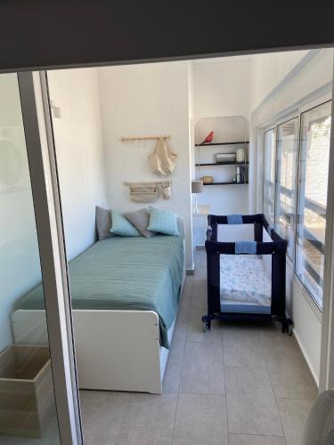 a small bedroom with a bed and a window at Apartamento Pedras Del Rei - Casa Azul in Tavira