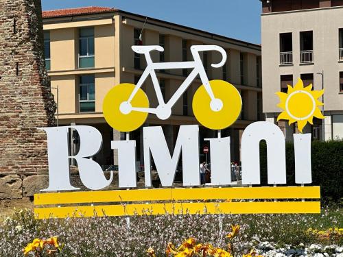 a large sign with a bike on it at Zuara9Room Rimini in Rimini