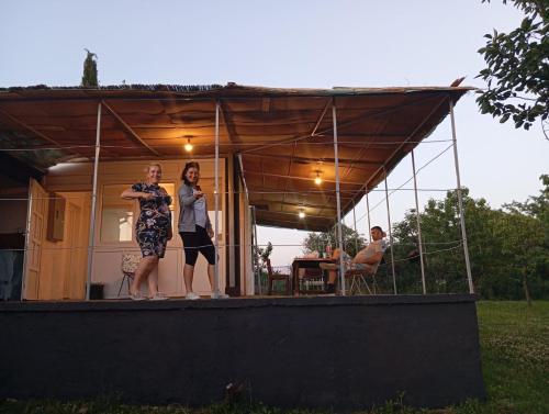 two women standing on the porch of a house at Kuća za odmor Fruška gora in Prnjavor