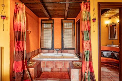 a bathroom with a bath tub in a room at Villa Nostos by Villa Plus in Svoronata