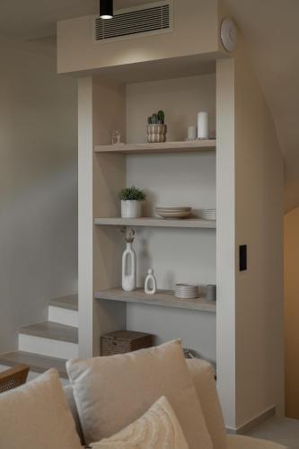 a living room with white shelves and a couch at Piccadill Luxury Villas in Methoni