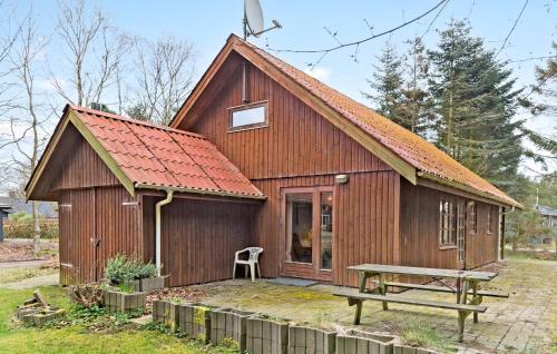 a small wooden house with a red roof at 4 Bedroom Pet Friendly Home In Thyholm in Thyholm