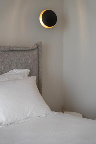 a bedroom with a bed with a black and white pillow at Piccadill Luxury Villas in Methoni