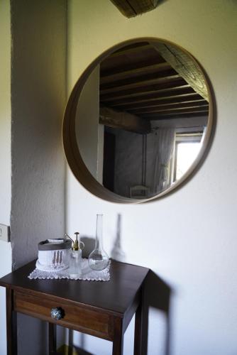 a table with a mirror and a cake on it at Agriturismo La Colombella in Bagni San Filippo