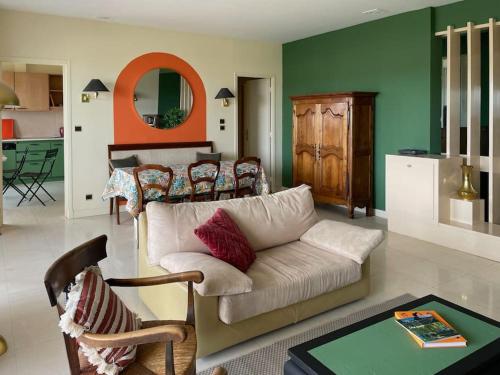 a living room with a couch and a table at Nid d'Aigle - Parking et vue exceptionnelle sur Carcassonne in Carcassonne