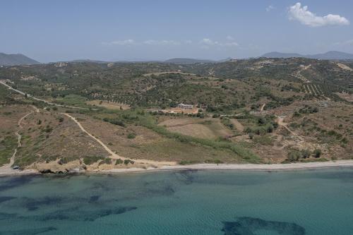 an aerial view of a beach and the ocean at Piccadill Luxury Villas in Methoni