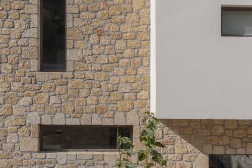 a stone fireplace in a brick wall with a window at Piccadill Luxury Villas in Methoni