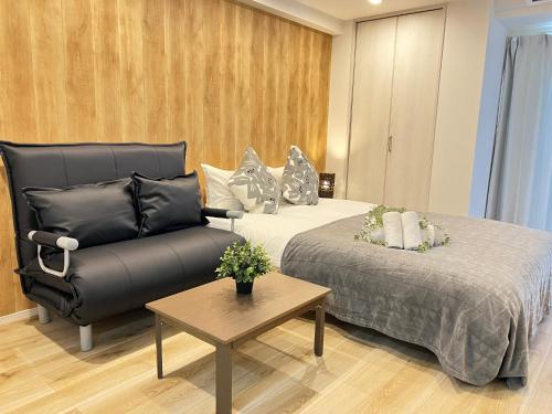 a hotel room with a bed and a couch at Ikebukuro Area 45 NishiikeApartment in Tokyo