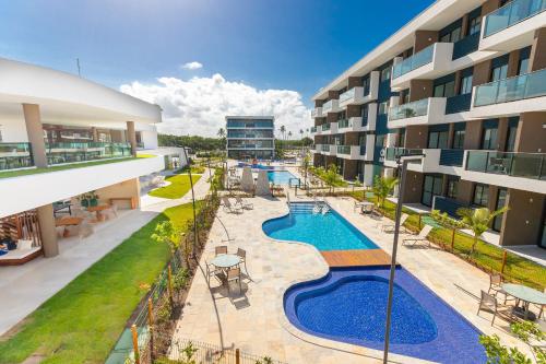 an aerial view of an apartment complex with a swimming pool at Makia Beach #D205 - Flat em Ipojuca by Carpediem in Porto De Galinhas