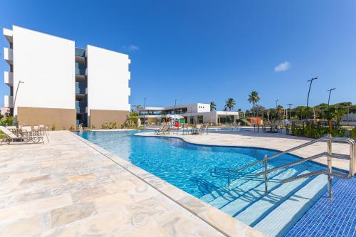 a swimming pool at a hotel with a resort at Makia Beach #D205 - Flat em Ipojuca by Carpediem in Porto De Galinhas