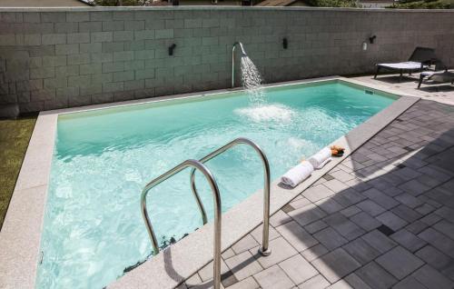 a swimming pool with a fountain in a yard at Beautiful Home In Rokovci in Rokovci