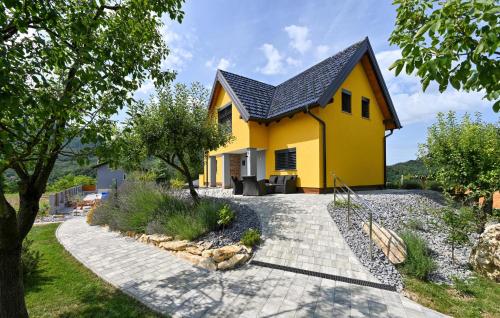 a yellow house with a black roof at 3 Bedroom Amazing Home In Lepoglava in Lepoglava