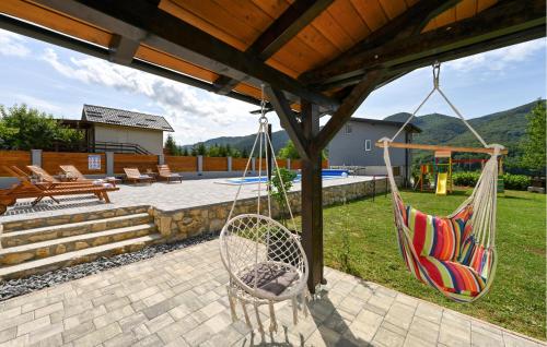 a hammock hanging from a pergola in a backyard at 3 Bedroom Amazing Home In Lepoglava in Lepoglava
