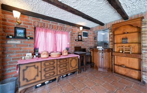 a kitchen with a counter and a brick wall at 3 Bedroom Amazing Home In Lepoglava in Lepoglava
