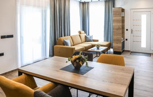 a living room with a wooden table and chairs at Beautiful Home In Rokovci in Rokovci