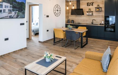 a living room with a table and chairs and a kitchen at Beautiful Home In Rokovci in Rokovci
