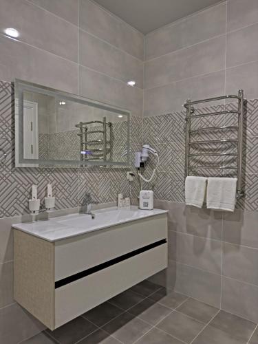 a bathroom with a sink and a mirror at Ametist Hotel Complex in Samarkand