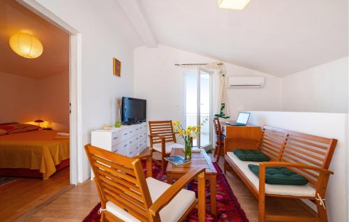 a room with chairs and a bedroom with a bed at Stunning Home In Rovanjska With Wifi in Rovanjska