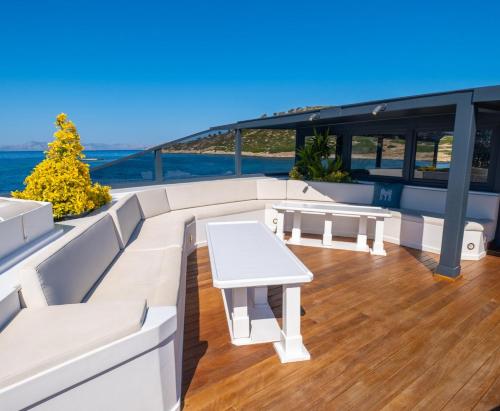 a deck on a yacht with a table and benches at Yalikavak Matilda Mega Yacth Hotel in Bodrum City