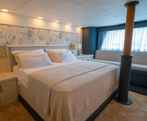 a bedroom with a large bed in a room at Yalikavak Matilda Mega Yacth Hotel in Bodrum City
