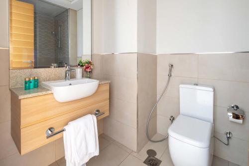 a bathroom with a sink and a toilet at Frank Porter - Azizi Aura in Dubai