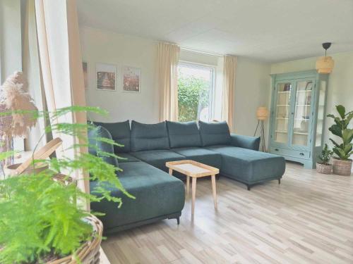 a living room with a blue couch and a table at Apartment in Denmark - Hygge Villa in Otterup
