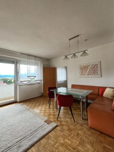 a living room with a table and a couch at Penthouse near Red Bull Ring in Knittelfeld