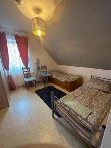 a room with two beds and a table and chairs at Apartmenthaus Iris&Jasmin in Friedrichshagen