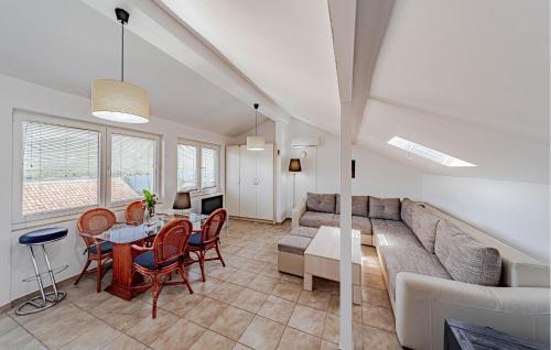 a living room with a couch and a table at 2 Bedroom Gorgeous Home In Hodilje in Hodilje