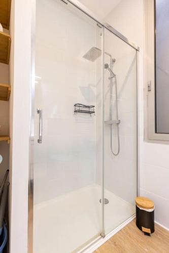 une douche avec une porte vitrée dans une salle de bain dans l'établissement 3 pièces à 5 min de la frontière de Monaco, à Beausoleil